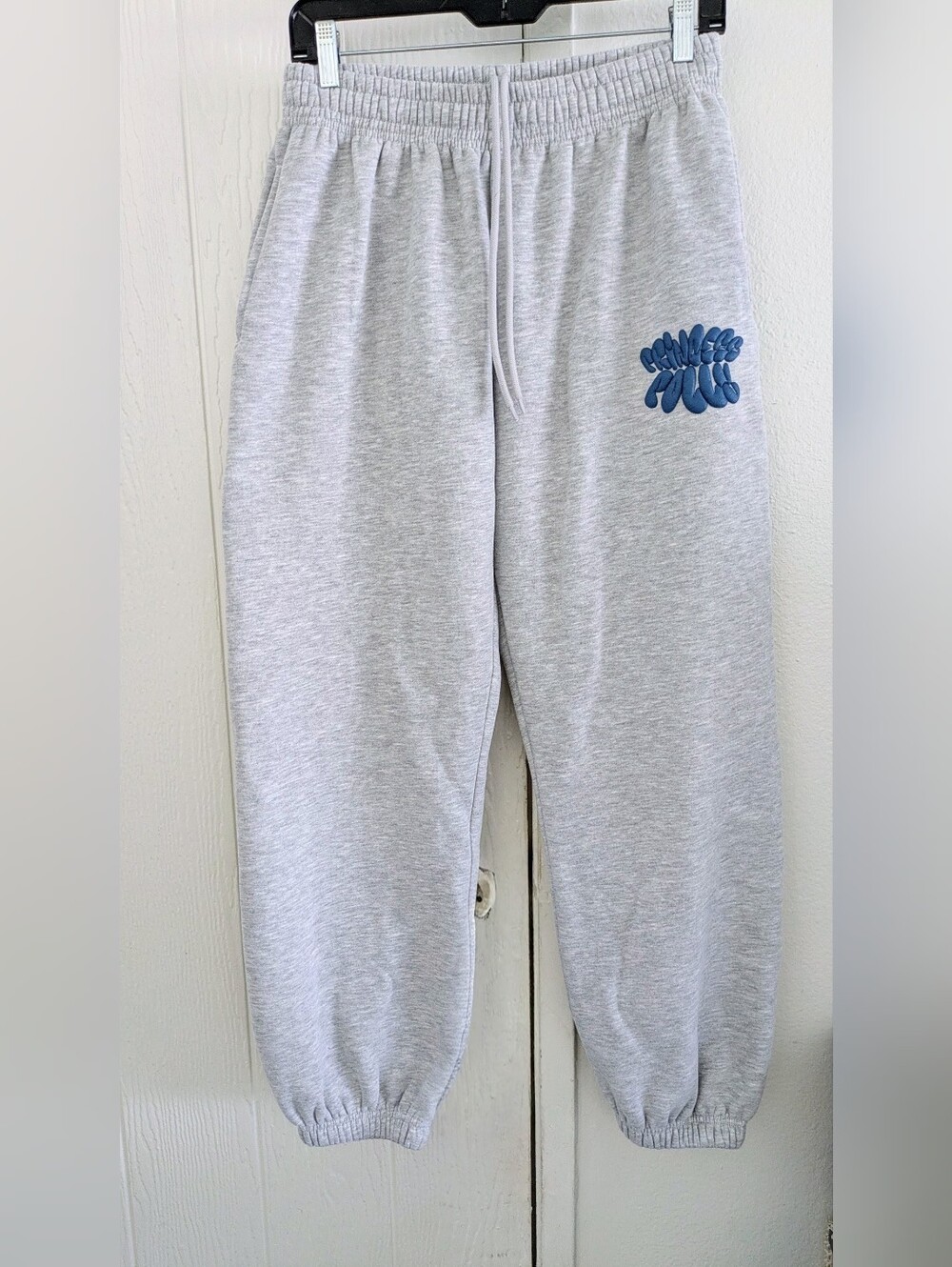 Puffy Logo Sweatpants
Princess Polly Gray Sweat Joggers with Blue Script Accent